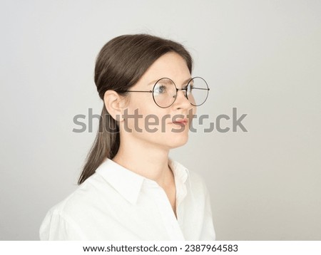 Young woman in profile with eyeglasses