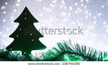 green red silhouette christmas tree gift white snowy background colourful christmas light and free space for text Myrealholiday