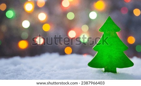 green red silhouette christmas tree gift white snowy background colourful christmas light and free space for text Myrealholiday