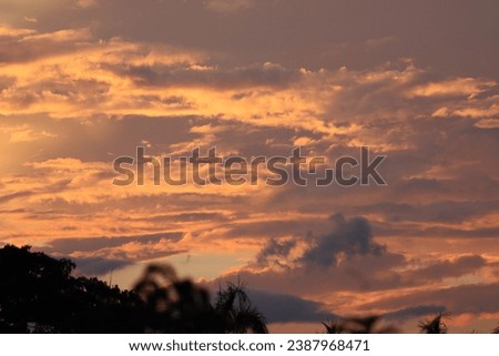 Beautiful sunset scenery with orange and blue cloudy sky. Golden sunset