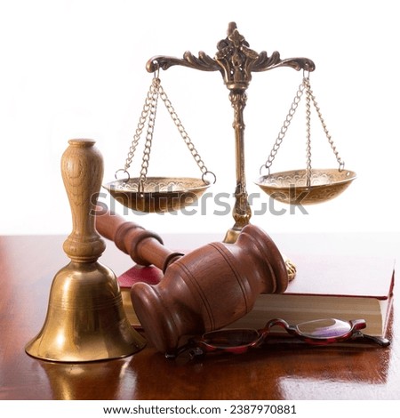 Gavel, bronze antique scales, bell and book on the table after the jury meeting