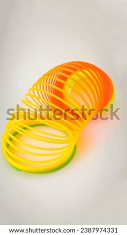 Classic colorful plastic spring toy on a white background