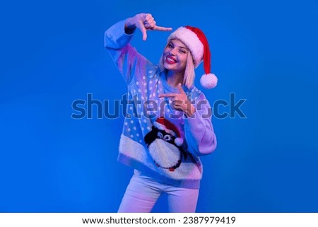 Photo of charming girl hands fingers show cadre gesture enjoy x-mas eve atmosphere isolated on blue color neon background