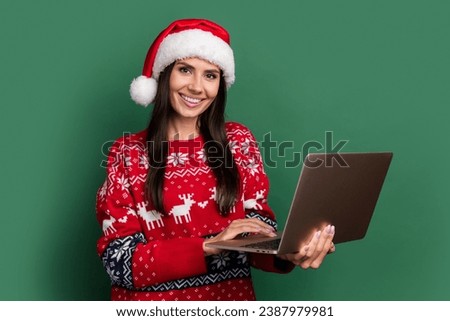 Photo of shiny positive lady santa helper dressed print xmas sweater texting twitter telegram facebook isolated green color background