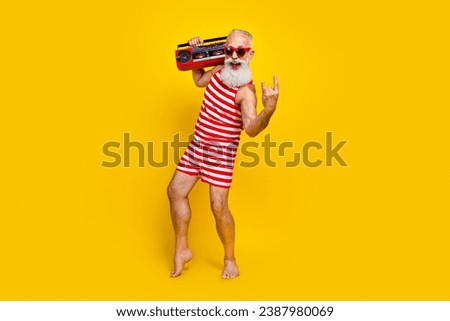 Full length photo of crazy brutal pensioner meloman holding hipsters boombox nostalgia at summer party isolated on yellow color background