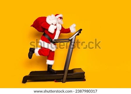 Full size profile photo of crazy elderly santa run treadmill hold new year gifts sack empty space isolated on yellow color background