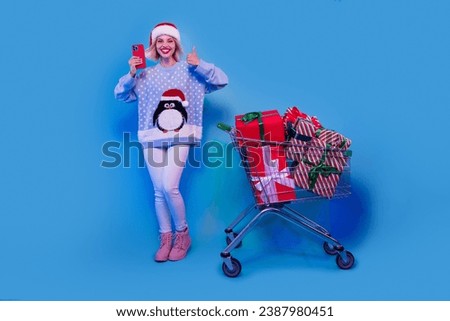 Photo of cheerful satisfied girl wear stylish penguin print clothes recommend advise eshopping thumb up isolated on blue color background