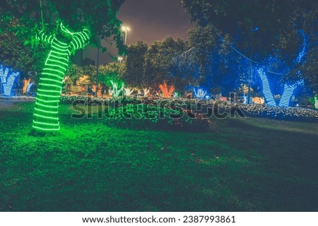 Christmas lights adorning trees of a city with blue,green and red colors, Christmas colors, night photography..