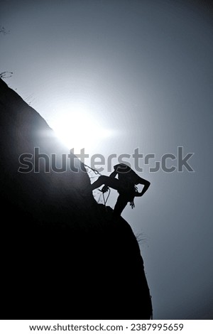 Climber fantom at the top of mountain Royalty-Free Stock Photo #2387995659