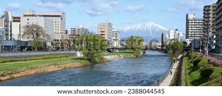 Panoramic of Iwate mountain and Morioka city and riverside walkway at Kitakami river in Morioka, Japan. Royalty-Free Stock Photo #2388044545