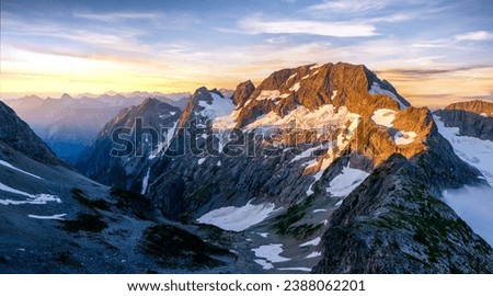 Sunset Illuminates A Panoramic View of Glaciers and Spider Mountain on the  Ptarmigan Traverse. 
North Cascades National Park, Washington. Royalty-Free Stock Photo #2388062201