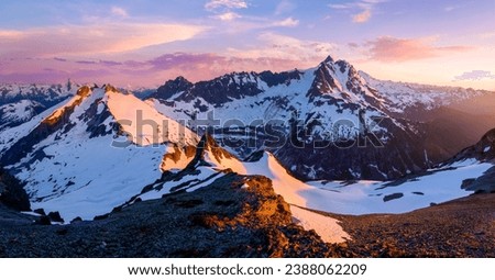 Sunset illuminates a Panoramic View of Mt Shuksan and Icy Peak. 
Ruth Mountain Summit, North Cascades National Park, Washingoton. Royalty-Free Stock Photo #2388062209