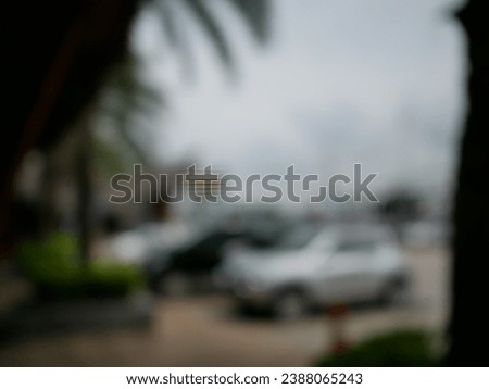 Blur focus of Empty car parking near the beach against a blue sky
