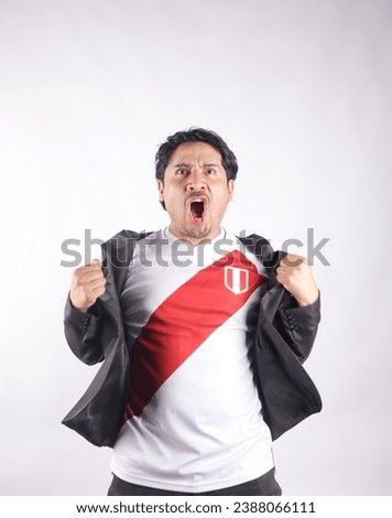 Picture of Peruvian Fanatic taking off his jacket shouting very happy. Concept of patriotism and people.