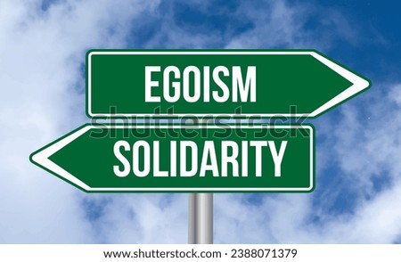 Egoism or solidarity road sign on cloudy sky background Royalty-Free Stock Photo #2388071379