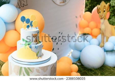 Boy's birthday party decoration and cake, lion king cartoon style decorations.