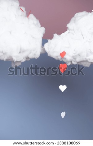 Decoration in a photo studio with clouds and hearts on a blue background.