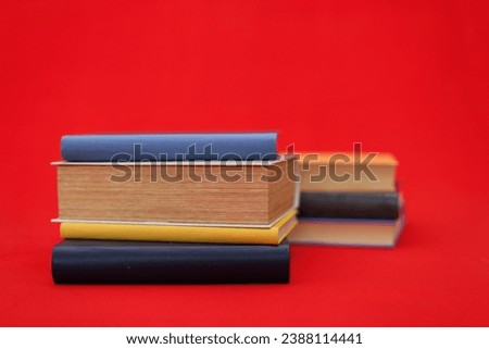 Stack of books on red background