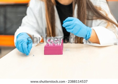 Close-up of the hands of an Unrecognizable woman working with samples in a laboratory
