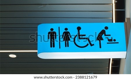 Toilets sign. Public restroom signs with a disabled access symbol and baby change room. Airport terminal interior