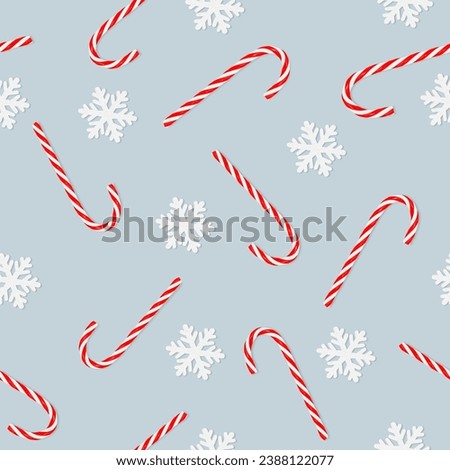 seamless pattern of candy cane and snowflakes on a blue background