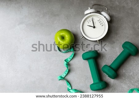 New Year for New Changes Healthy 2024.  Fresh vegetable fruits and healthy food for sport equipment for women diet slimming weight loss.  Healthy and Holiday Concept Royalty-Free Stock Photo #2388127955