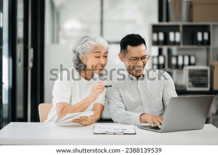 Businessman using laptop computer in office. Happy people, entrepreneur, small business owner working online.