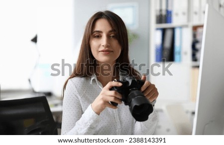 Portrait of pretty businesslady with modern camera. Wonderful woman looking with gladness and joyfulness . Business and art design concept. Blurred background Royalty-Free Stock Photo #2388143391