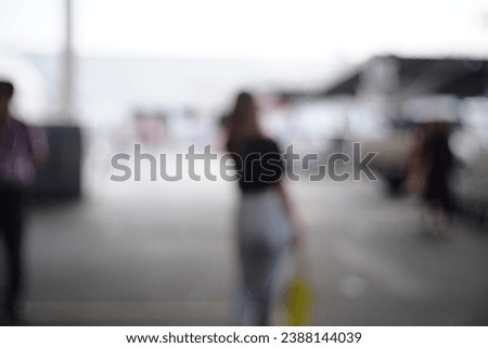Blur Street background.Picture of blurred cityscape at street.Blur focus of women walk on outdoor car park.