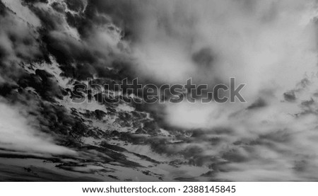 Dramatic sky with clouds, natural background for text, black and white, invert photo