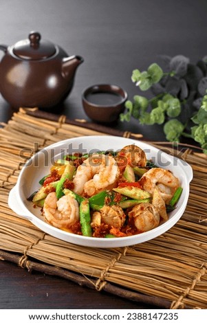 traditional chinese seafood big tiger fresh prawn vegetables with XO premium sauce in plate pot on grey vintage background asian cafe hotel luxury halal food restaurant banquet menu