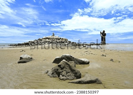 Scary giant black statue in the sea Puek Tian beach Phetchaburi, Thailand Royalty-Free Stock Photo #2388150397