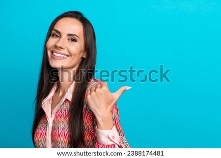 Portrait of adorable young latin girl directing finger empty space demonstrating ad adv ads isolated over teal blue color background