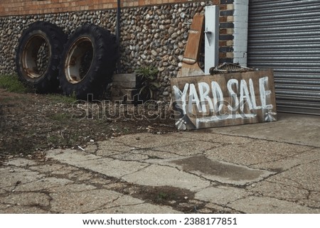 A sign that reads "Yard Sale" next to some old tyres.

Taken in the village of Glandford in North Norfolk, England.