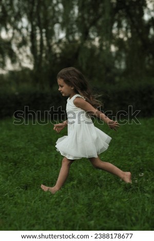 Barefoot and carefree, a child races across the grass, a picture of pure happiness. Such images resonate with the movement towards mindfulness and present living.