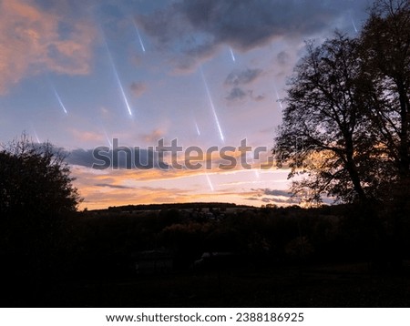 Meteor shower in the sky at sunset. Falling meteorites on the background of clouds. Landscape with shooting stars.