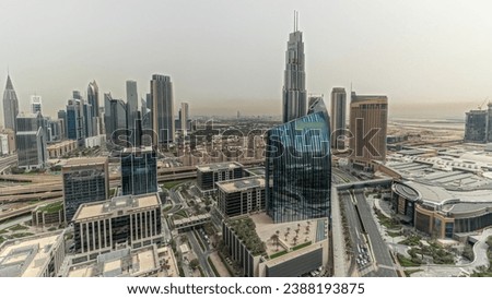 Panorama showing futuristic Dubai Downtown and financial district skyline aerial timelapse. Many towers and skyscrapers with traffic on streets. City walk district on a background