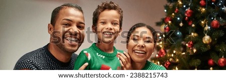 modern cheerful african american family smiling at camera with Christmas tree on backdrop, banner