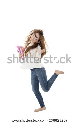 Excited female student posing while holding notebook against a white background