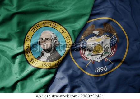 big waving colorful national flag of utah state and flag of washington state . macro