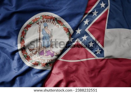 big waving colorful national flag of mississippi state and flag of virginia state . macro