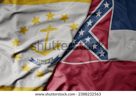 big waving colorful national flag of mississippi state and flag of rhode island state . macro