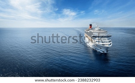 Aerialview of a generic cruise ship traveling with speed over calm ocean with copy space