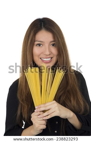 Happy woman holding raw spaghetti pasta against a white background