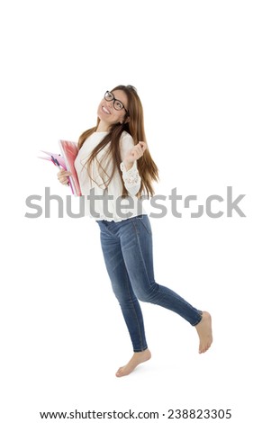 Female student posing while holding notebook against a white background