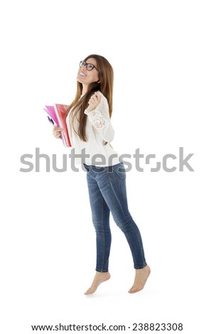 Young woman student posing while holding notebook against a white background