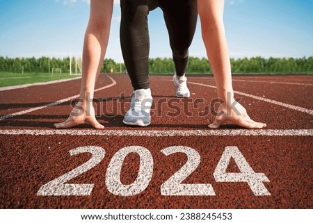 happy new year 2024. concept of starting a business or career in the new year. woman preparing for running. beginning of the 2024 year. transition to a new level concept. hope and expectation in 2024 Royalty-Free Stock Photo #2388245453