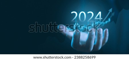 Explore the future of finance with this image featuring a businessman's hands displaying a virtual screenshot of the economic outlook, stocks, and trading markets for 2024 Royalty-Free Stock Photo #2388258699
