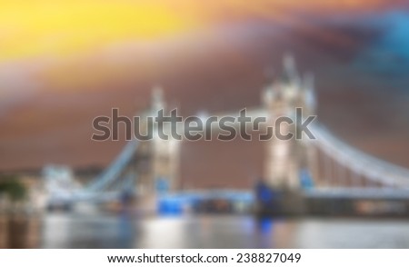 Blurred view of Tower Bridge in London at sunset.