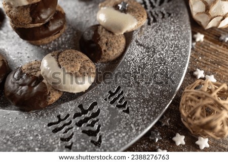 Poppy seed cookies  with chocolate glaze for christmas on a silver plate